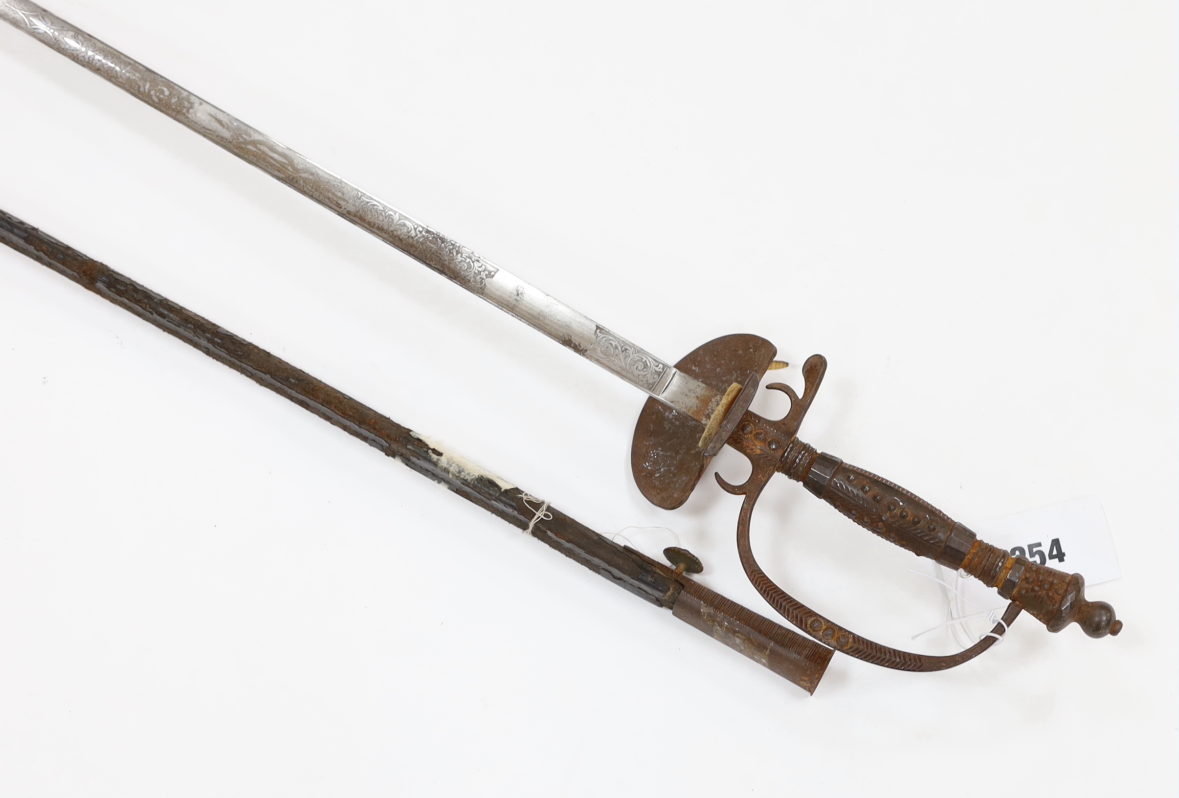 An English cut steel hilted dress court sword, c.1900, polished blade etched at forte, iron hilt slightly rusted, in its leather scabbard, blade 79cm